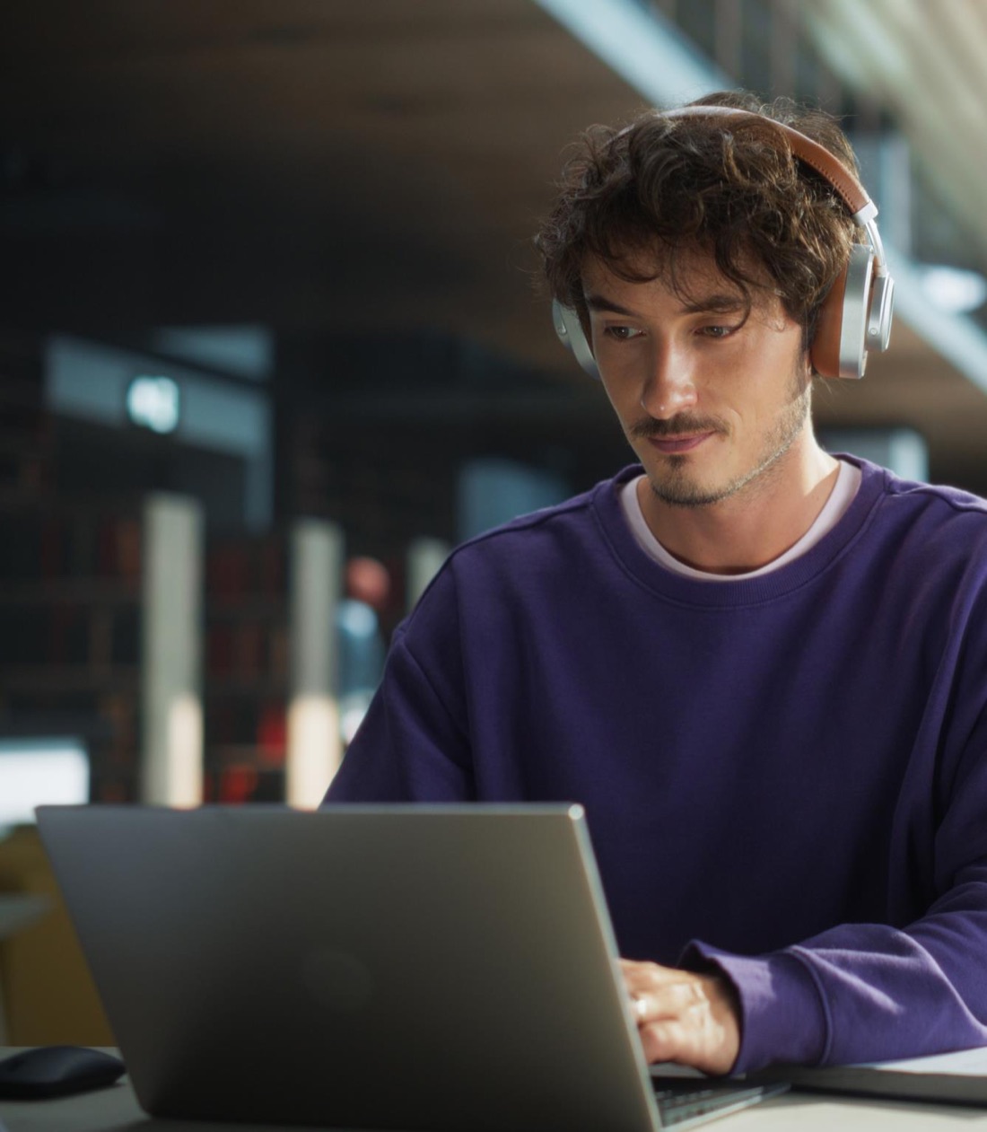 Expert working remotely on a laptop with headphones