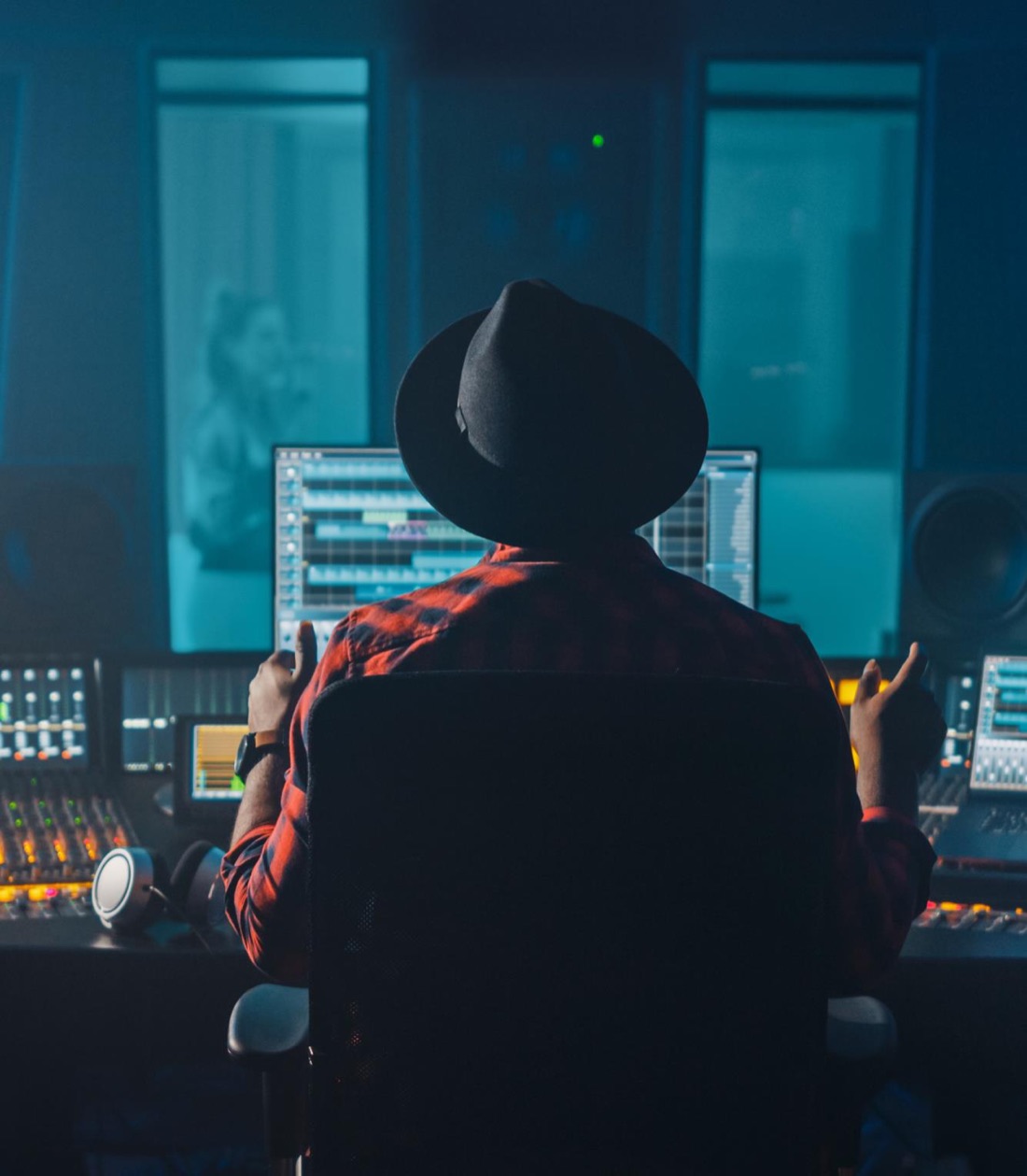Audio engineer working at a mixing console in a recording studio